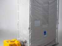 A portable shower tent with a yellow heater.