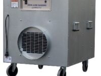 A gray machine with wheels and a large air vent.