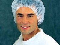 A man wearing white lab coat and head covering.