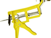 A yellow tool is holding a pipe with a handle.