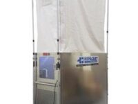 A large metal enclosure with a white curtain.